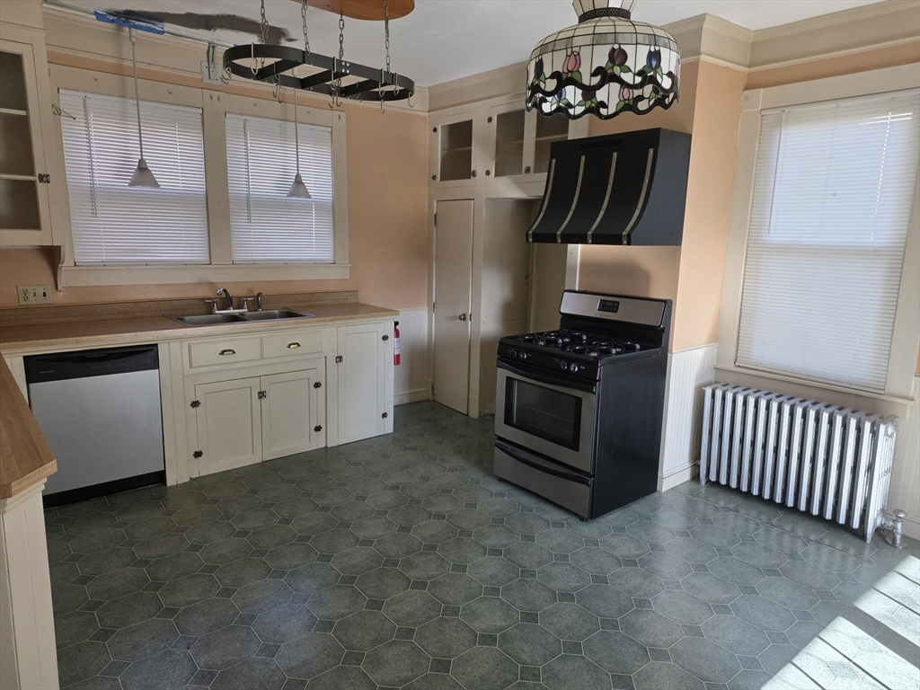 177 Highland Avenue, Unit 1 Fall River, MA 02720 - Photo 21 of 36 a kitchen with granite countertop a stove a sink and a refrigerator