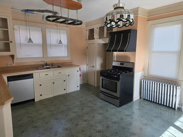 a kitchen with stainless steel appliances granite countertop a stove and a sink