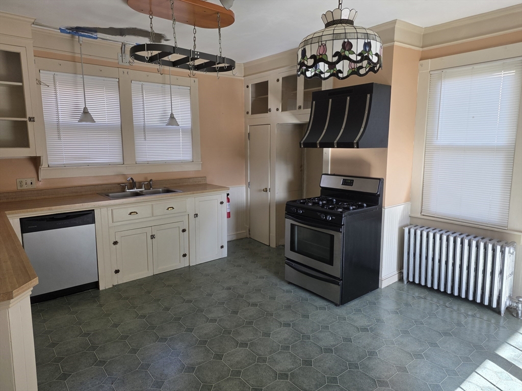 177 Highland Avenue, Unit 1 Fall River, MA 02720 - Photo 22 of 36 a kitchen with stainless steel appliances granite countertop a stove and a sink