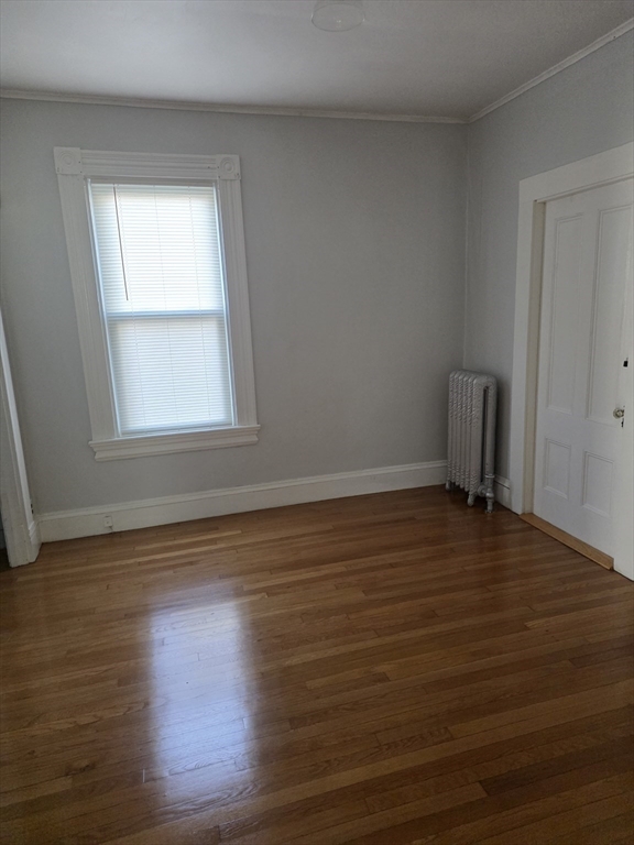 177 Highland Avenue, Unit 1 Fall River, MA 02720 - Photo 29 of 36 a view of an empty room with wooden floor and a window