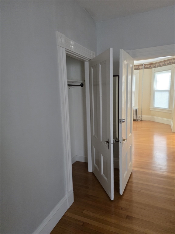 177 Highland Avenue, Unit 1 Fall River, MA 02720 - Photo 34 of 36 a view of a hallway with wooden floor and closet area