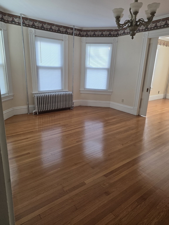 177 Highland Avenue, Unit 1 Fall River, MA 02720 - Photo 5 of 36 an empty room with wooden floor and windows