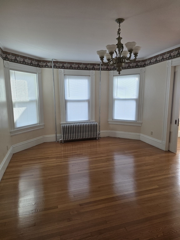 177 Highland Avenue, Unit 1 Fall River, MA 02720 - Photo 6 of 36 a view of an empty room with wooden floor and a window
