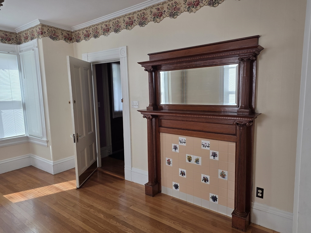 177 Highland Avenue, Unit 1 Fall River, MA 02720 - Photo 7 of 36 a view of a hallway with wooden floor and staircase