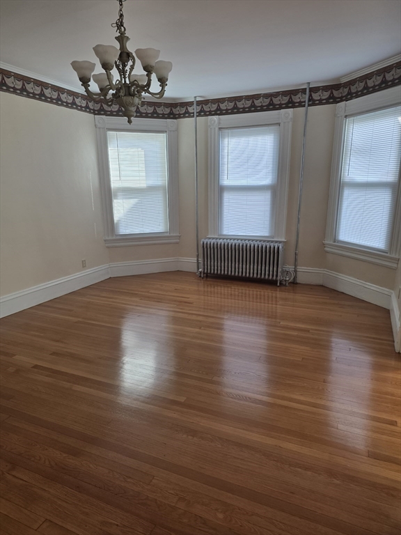 177 Highland Avenue, Unit 1 Fall River, MA 02720 - Photo 9 of 36 a view of a room with wooden floor window and fireplace