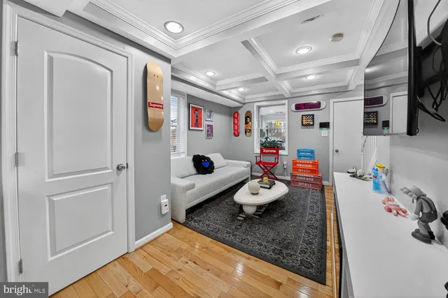 a kitchen with stainless steel appliances granite countertop a stove a sink dishwasher a dining table and chairs with wooden floor