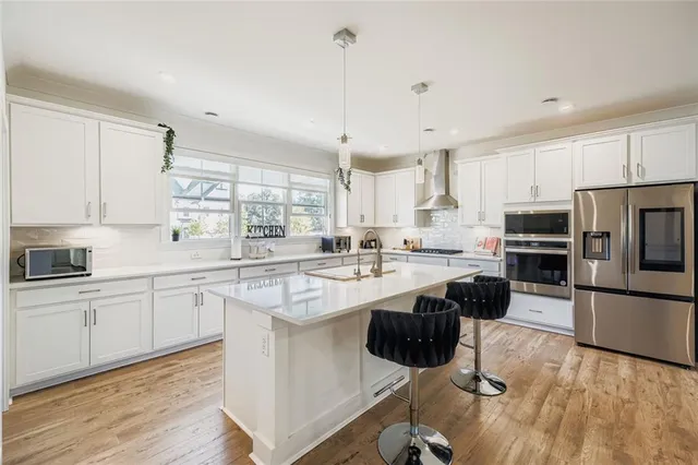 a kitchen with appliances cabinets and a counter top space