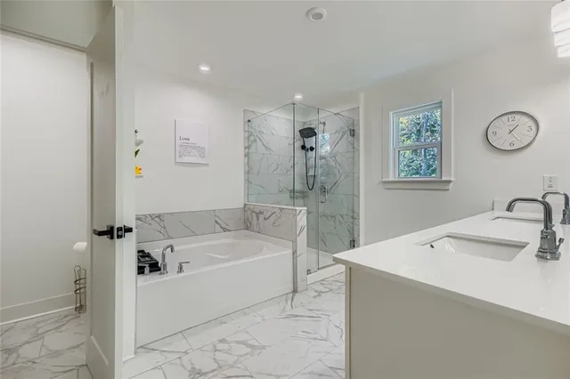 a bathroom with a tub sink and mirror