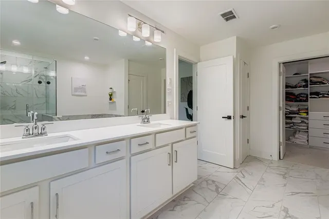 a spacious bathroom with a double vanity sink mirror and double