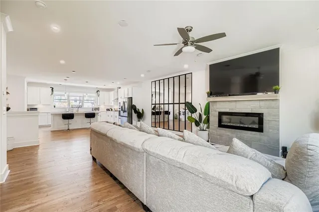 a living room with furniture a fireplace and a flat screen tv