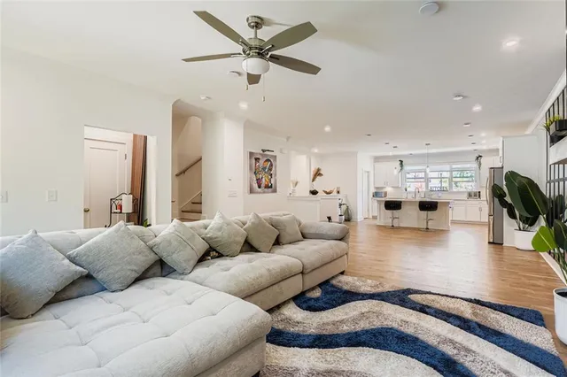 a living room with furniture and a view of kitchen