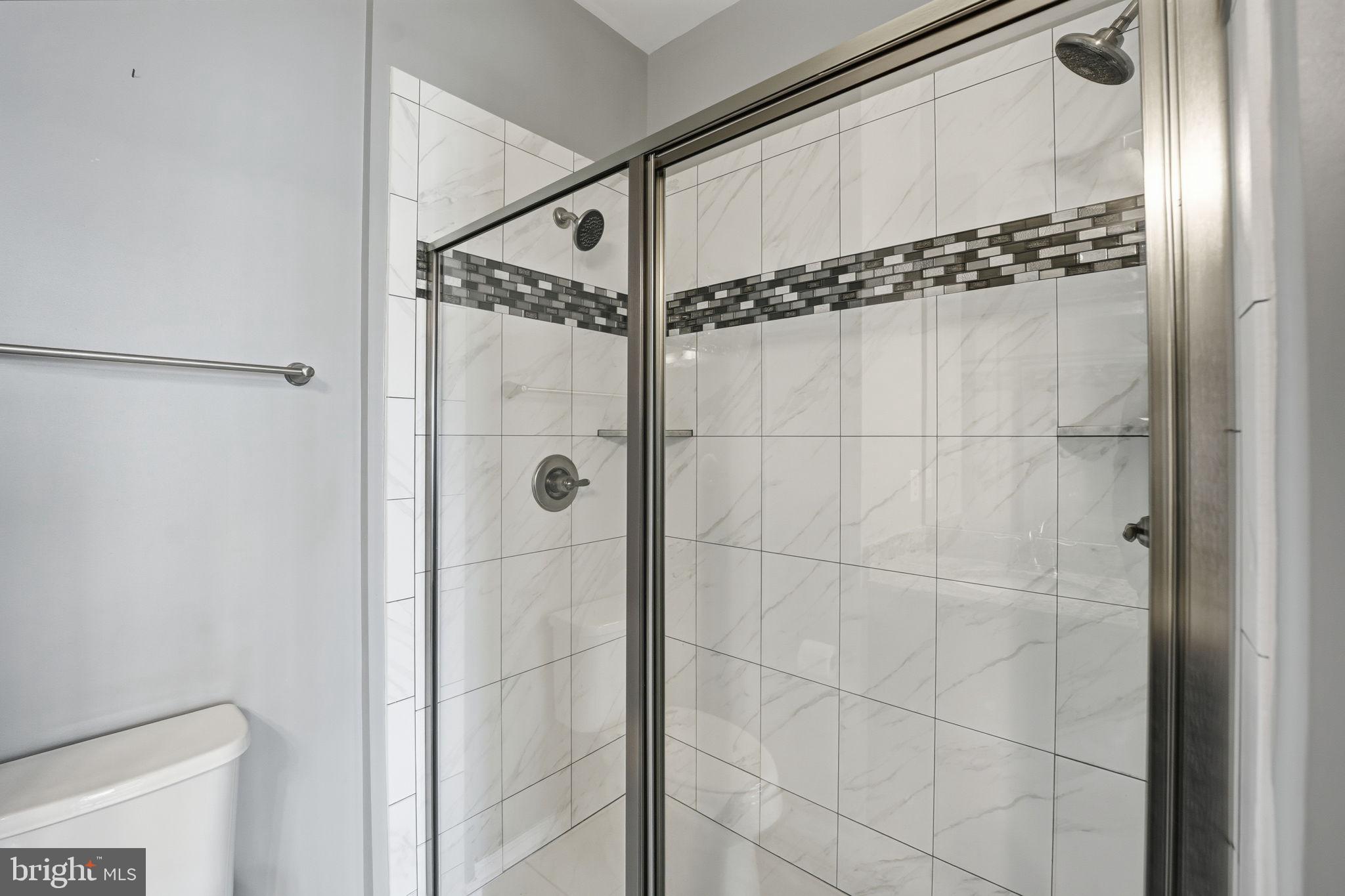 14619 Featherstone Gate Drive Woodbridge, VA 22191 - Photo 16 of 20 a bathroom with a glass door shower