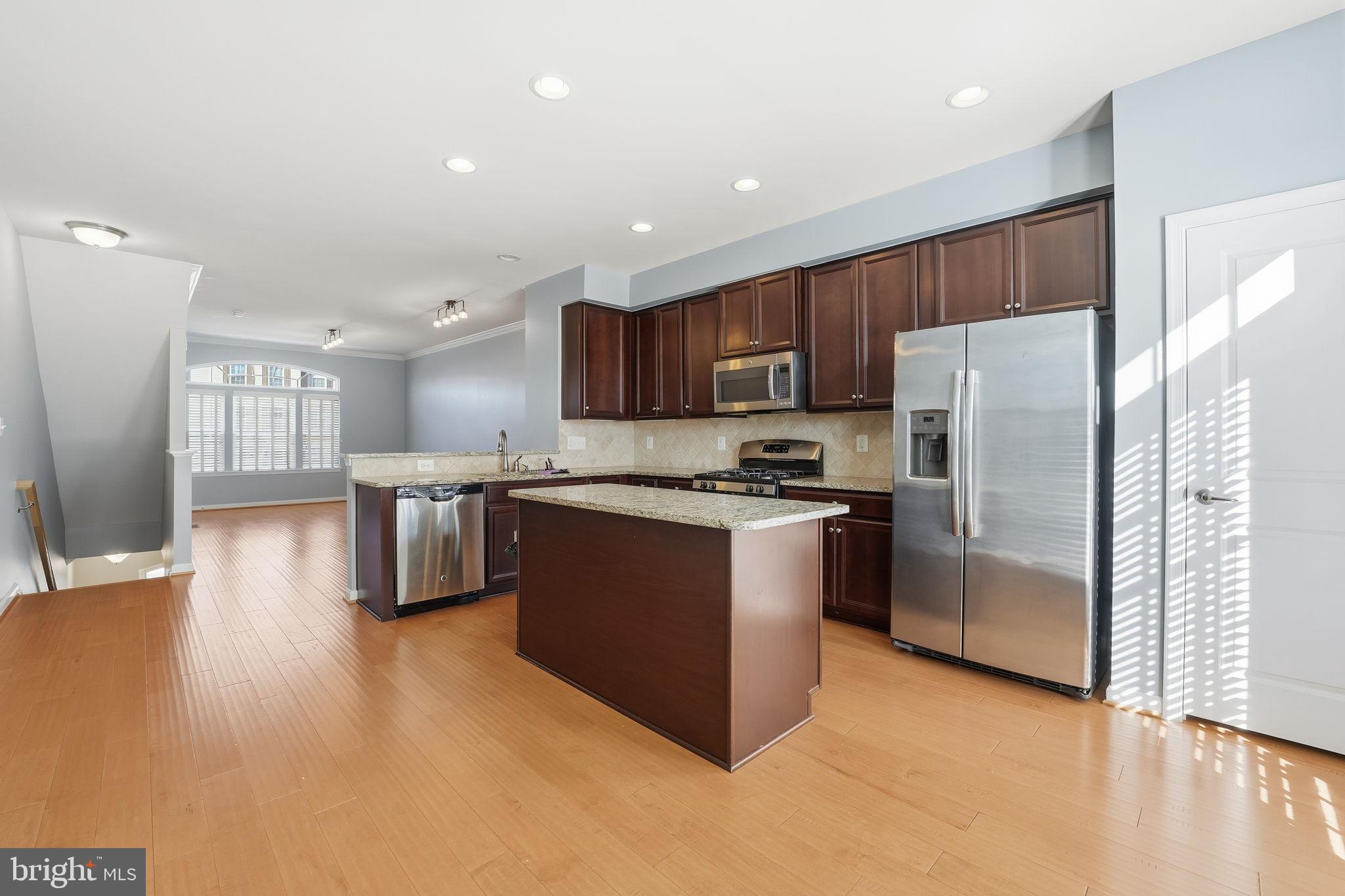 14619 Featherstone Gate Drive Woodbridge, VA 22191 - Photo 8 of 20 a kitchen with stainless steel appliances granite countertop a refrigerator sink and cabinets