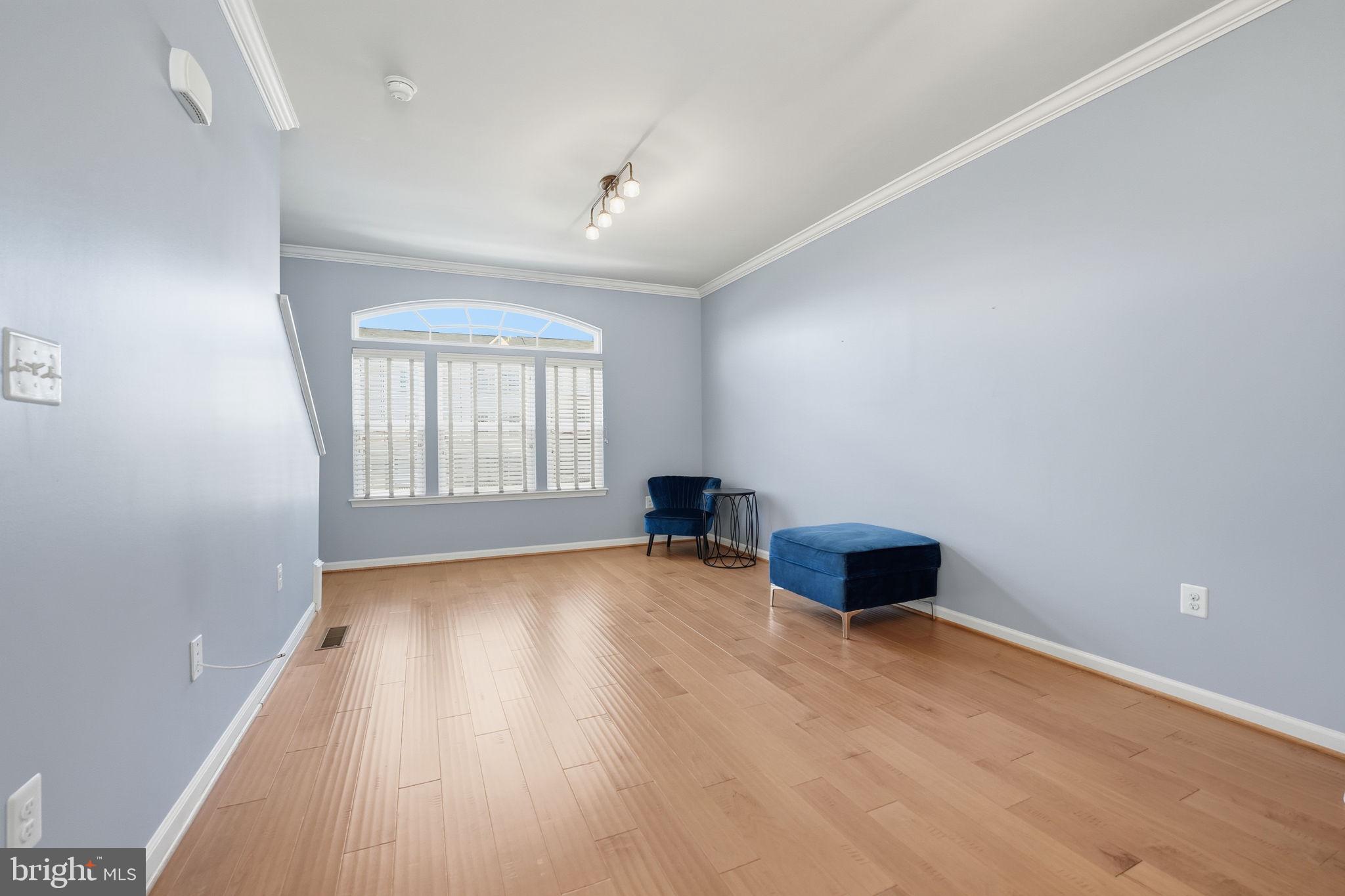 14619 Featherstone Gate Drive Woodbridge, VA 22191 - Photo 10 of 20 an empty room with wooden floor and windows