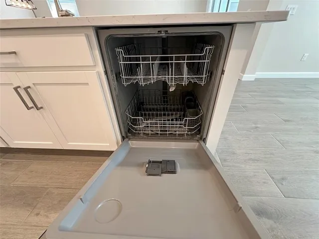 a bathroom with a granite countertop toilet a sink and a mirror
