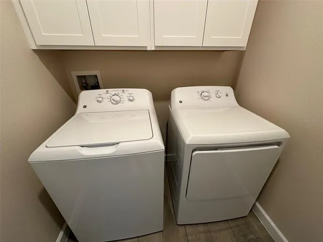 an empty room with a ceiling fan and window