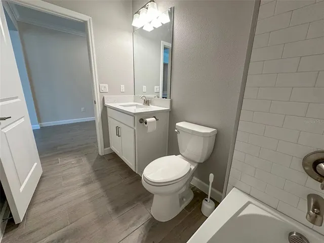 a living room with lots of furniture a clock and a chandelier