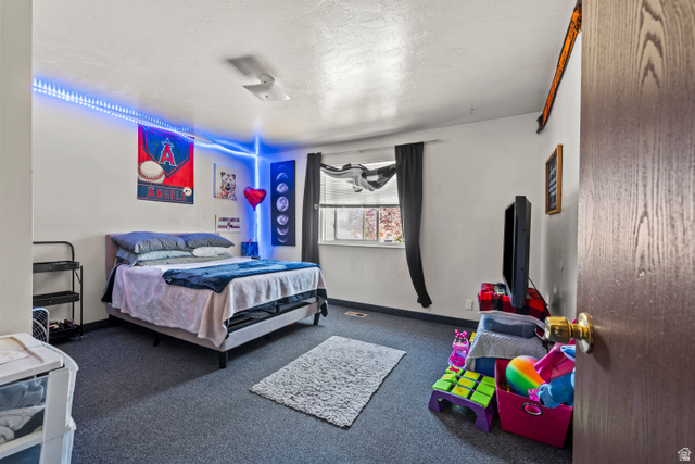 2402 710 North Provo, UT 84601 - Photo 6 of 15 Room featuring wall-to-wall carpeting and a window with dark drapes