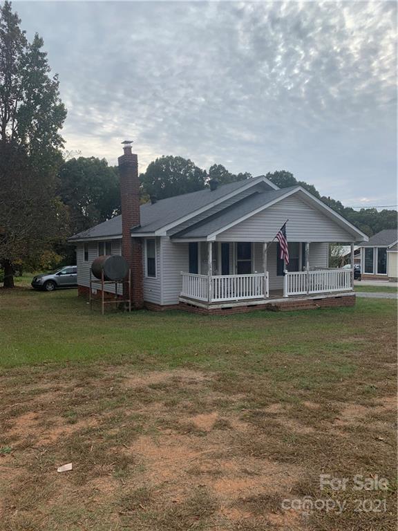 4215 Poplar Tent Road Concord, NC 28027 - Photo 2 of 22 a front view of a house with a garden and lake view