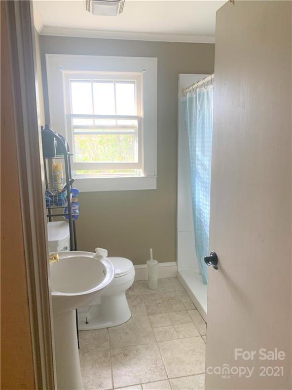 4215 Poplar Tent Road Concord, NC 28027 - Photo 14 of 22 a bathroom with a sink a toilet and a mirror