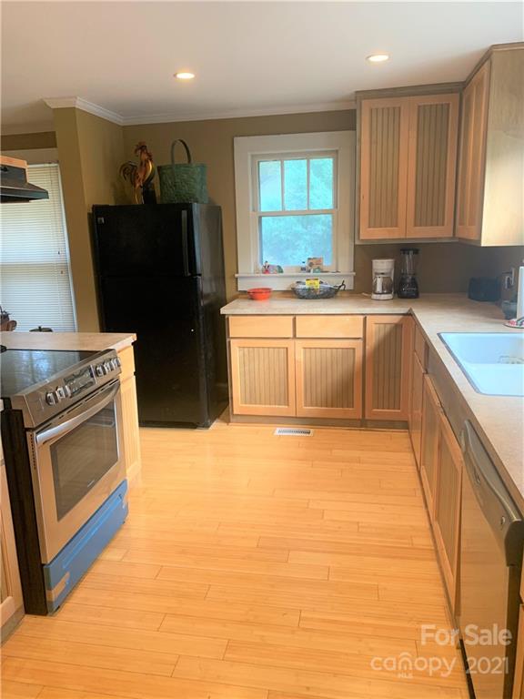 4215 Poplar Tent Road Concord, NC 28027 - Photo 5 of 22 a kitchen with stainless steel appliances granite countertop a stove a sink dishwasher and a refrigerator
