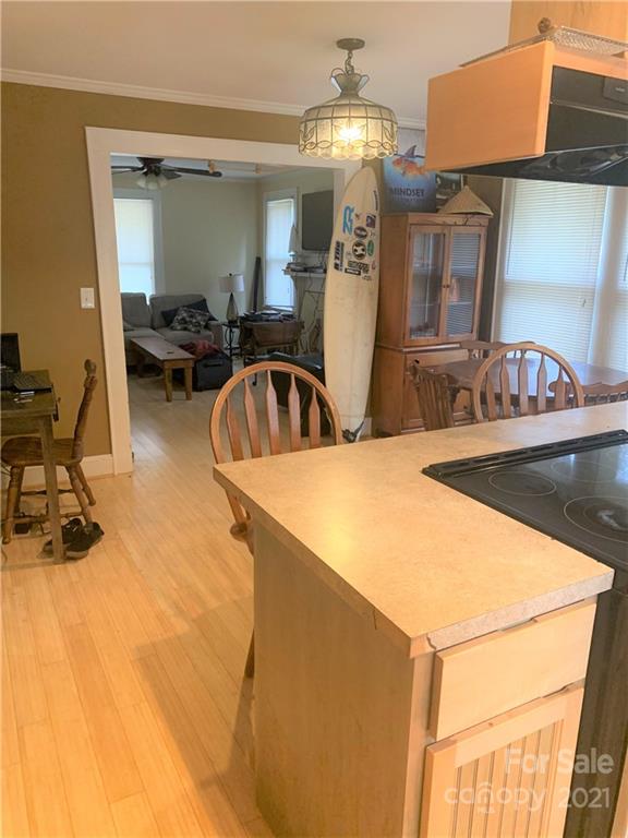 4215 Poplar Tent Road Concord, NC 28027 - Photo 9 of 22 a kitchen with stainless steel appliances kitchen island a chandelier