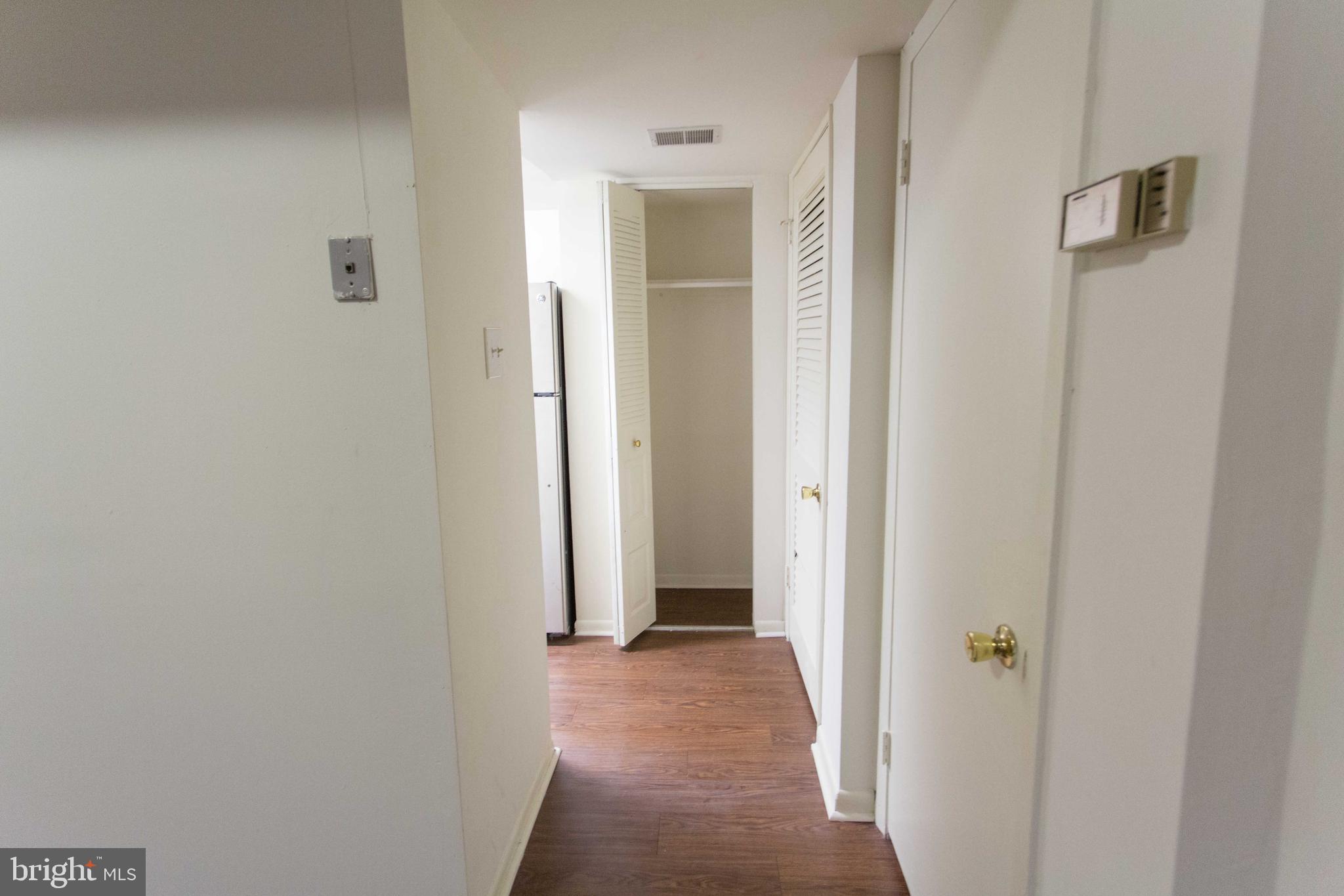 2031-8 South Street, Unit 123 Philadelphia, PA 19146 - Photo 15 of 31 a view of a hallway with wooden floor