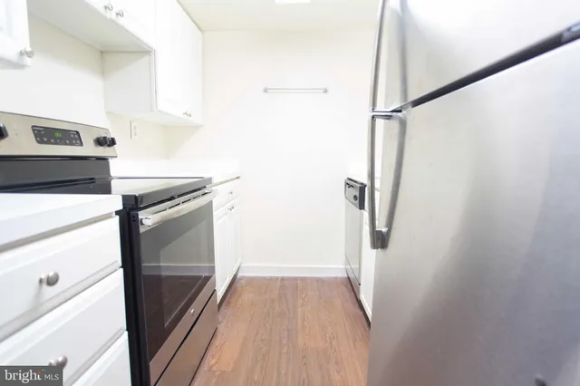 a kitchen with a refrigerator and a stove