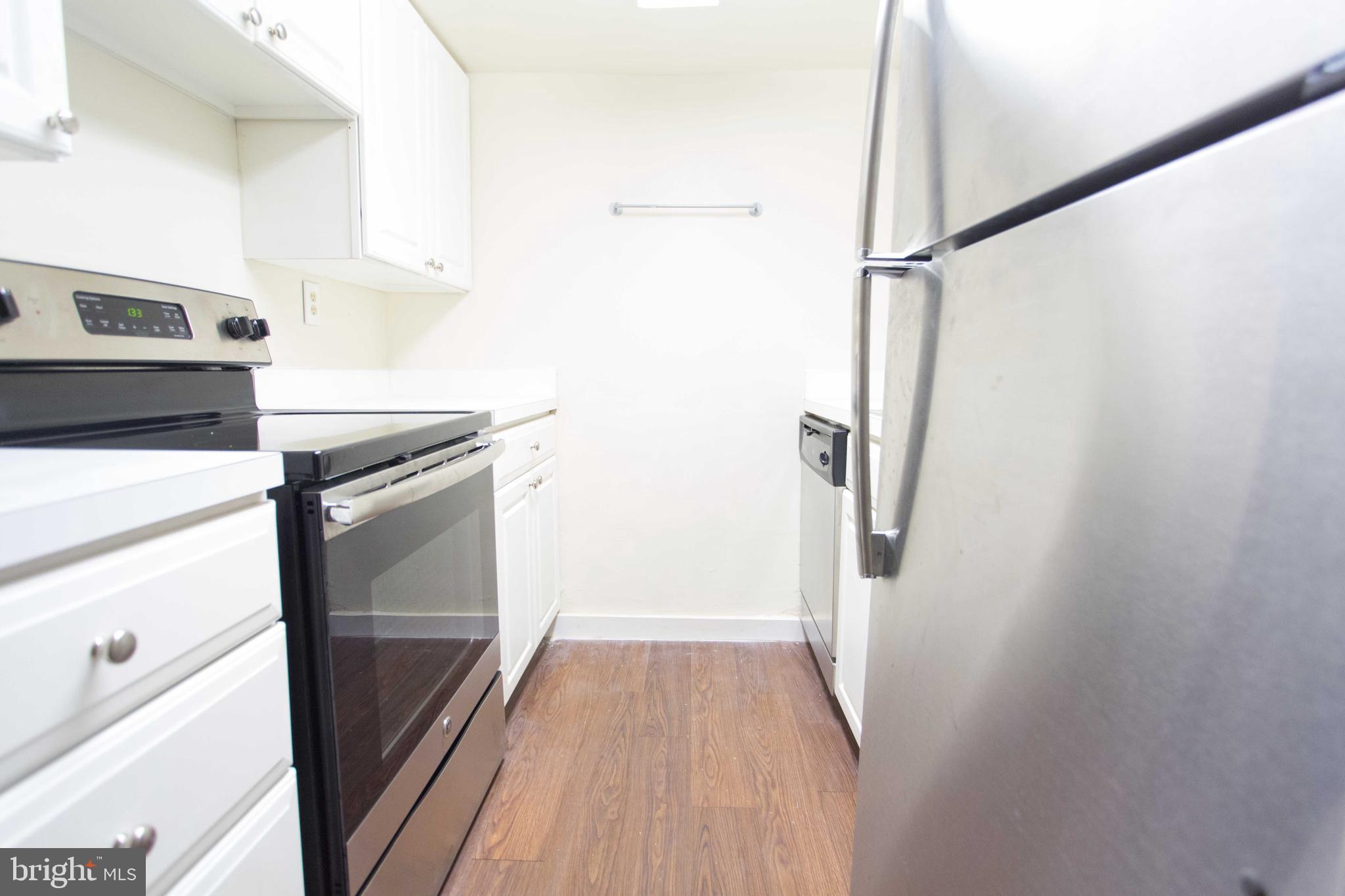 2031-8 South Street, Unit 123 Philadelphia, PA 19146 - Photo 19 of 31 a kitchen with a refrigerator and a stove