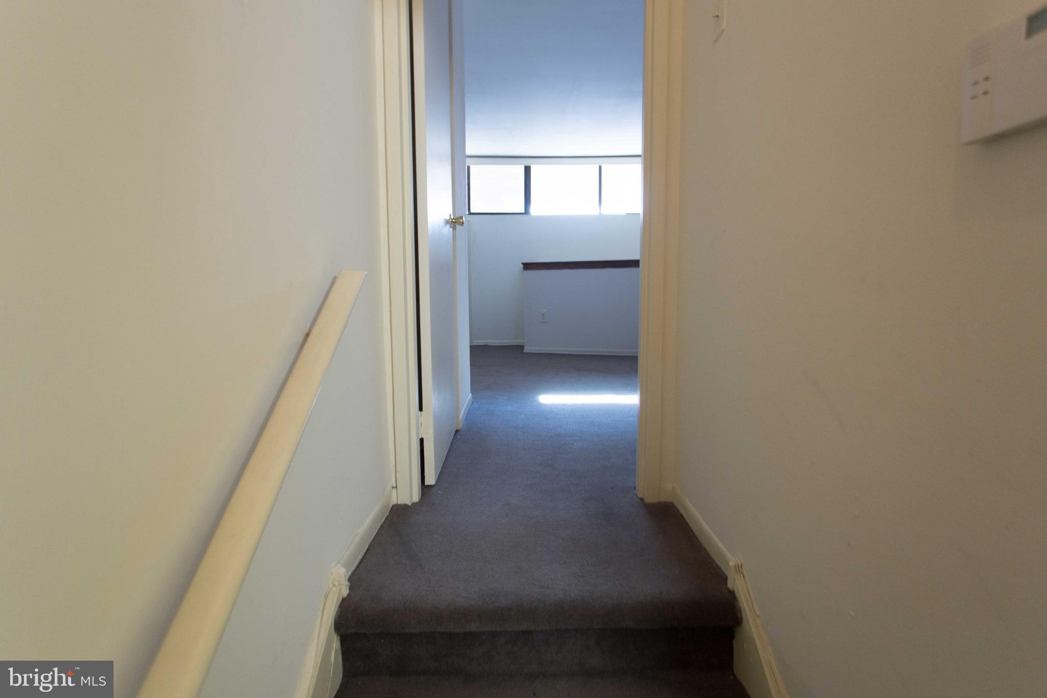 2031-8 South Street, Unit 123 Philadelphia, PA 19146 - Photo 22 of 31 a view of a hallway with wooden floor and staircase