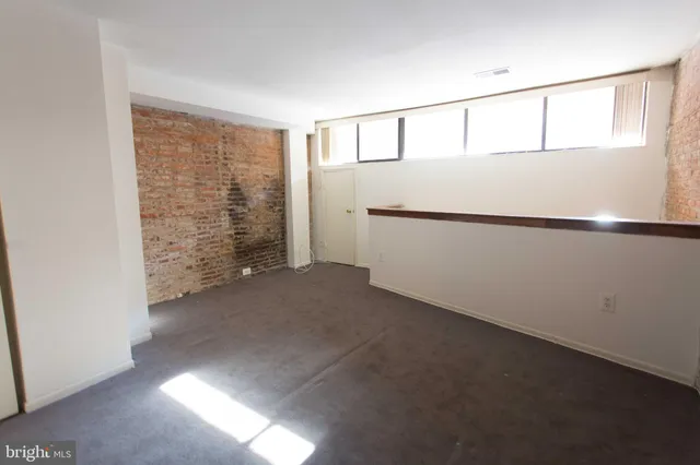 a view of an empty room with closet area