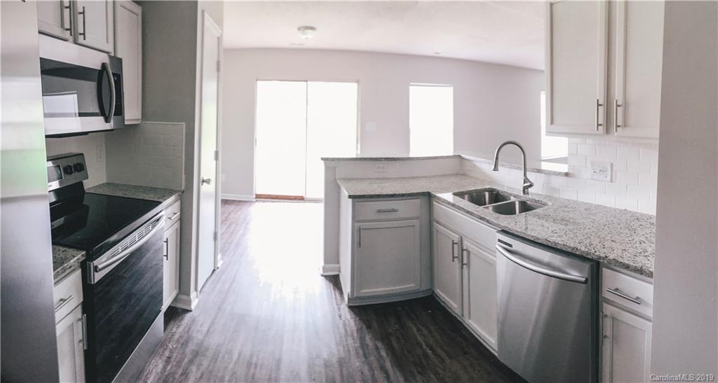 2039 Pimpernel Road Charlotte, NC 28213 - Photo 11 of 44 a kitchen with granite countertop a sink stove and cabinets