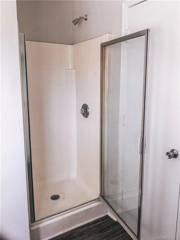2039 Pimpernel Road Charlotte, NC 28213 - Photo 14 of 44 a bathroom with a glass shower door