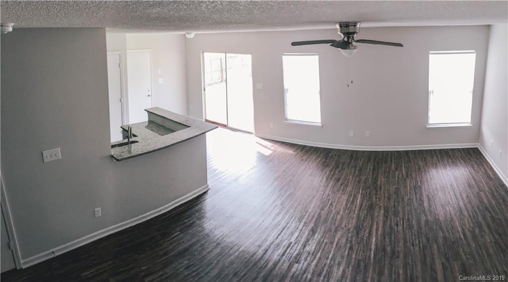 2039 Pimpernel Road Charlotte, NC 28213 - Photo 21 of 44 a view of empty room with wooden floor and fan
