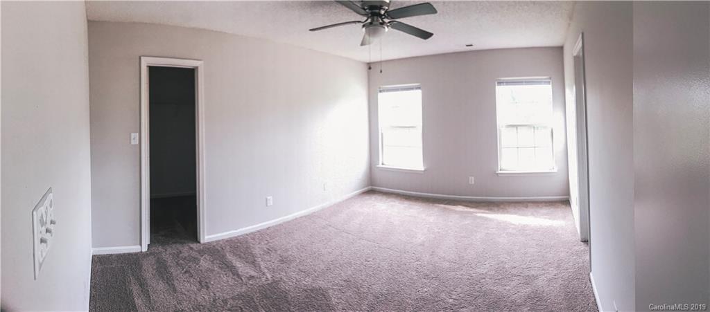 2039 Pimpernel Road Charlotte, NC 28213 - Photo 22 of 44 an empty room that has a window and a fan