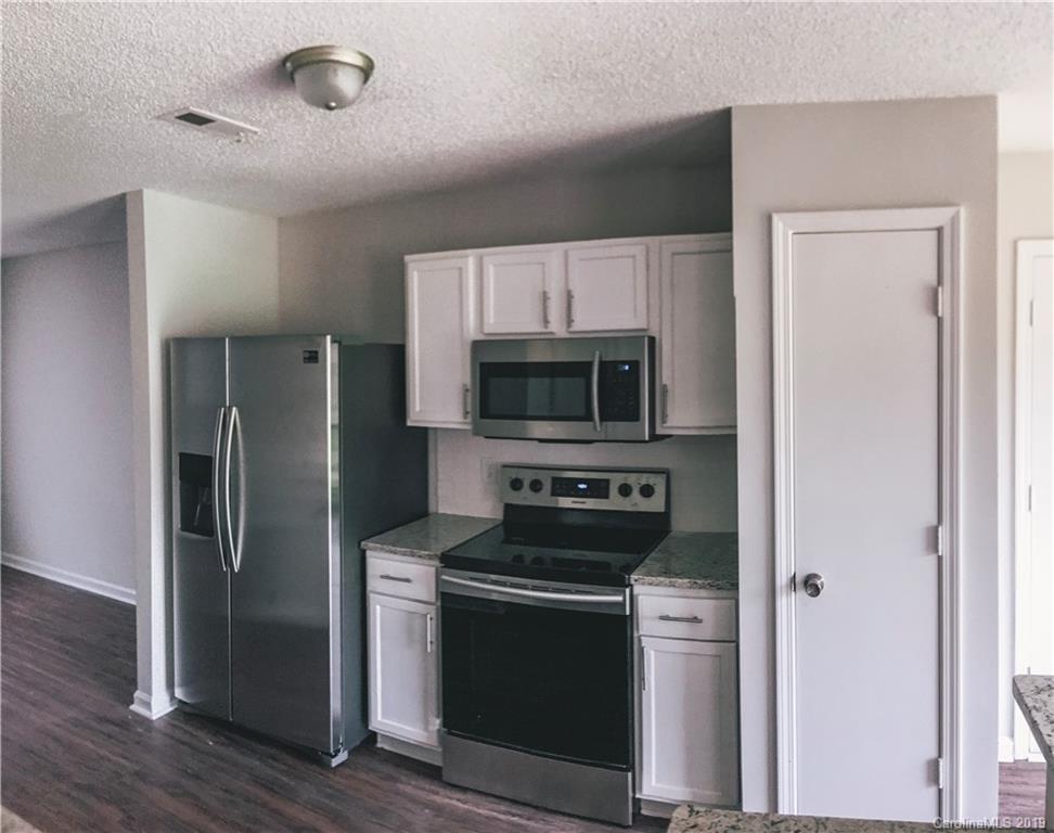 2039 Pimpernel Road Charlotte, NC 28213 - Photo 28 of 44 a kitchen with stainless steel appliances a refrigerator stove and microwave