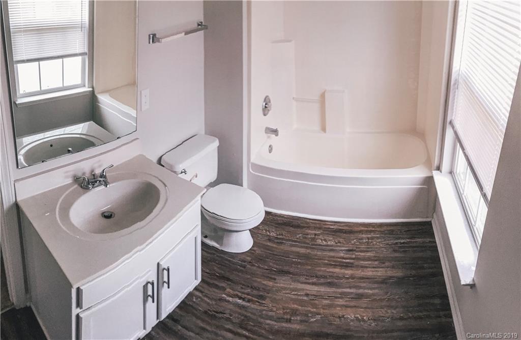 2039 Pimpernel Road Charlotte, NC 28213 - Photo 30 of 44 a bathroom with a sink toilet a shower and a mirror