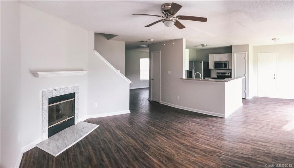 2039 Pimpernel Road Charlotte, NC 28213 - Photo 34 of 44 a view of a livingroom with wooden floor and a ceiling fan