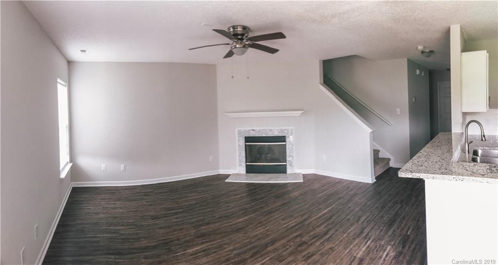 2039 Pimpernel Road Charlotte, NC 28213 - Photo 36 of 44 wooden floor in an empty room with a fireplace