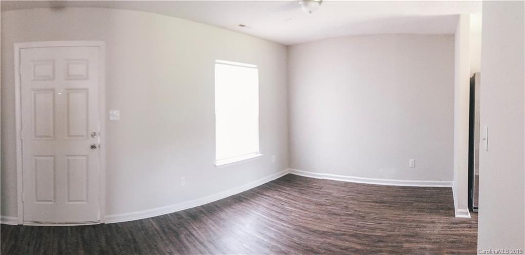 2039 Pimpernel Road Charlotte, NC 28213 - Photo 37 of 44 a view of an empty room with wooden floor and a window