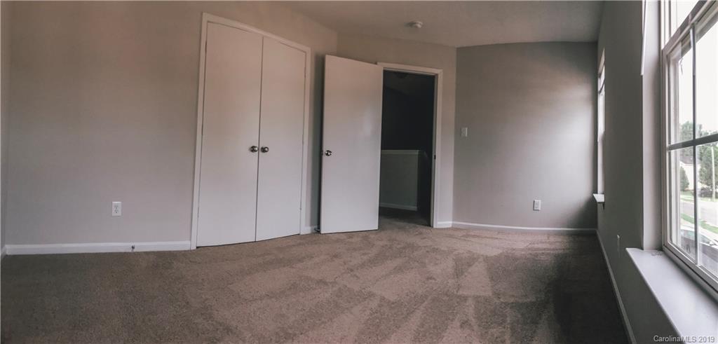 2039 Pimpernel Road Charlotte, NC 28213 - Photo 39 of 44 an empty room with windows and entrance to other room