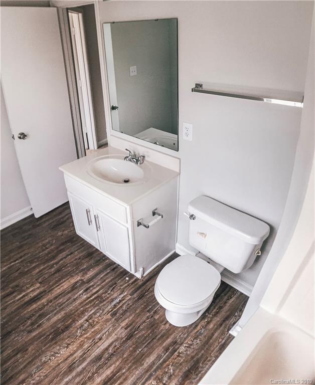 2039 Pimpernel Road Charlotte, NC 28213 - Photo 40 of 44 a bathroom with a sink a toilet and mirror