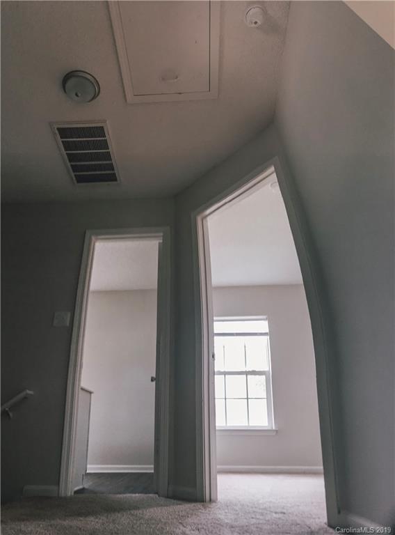 2039 Pimpernel Road Charlotte, NC 28213 - Photo 41 of 44 a view of an empty room with wooden floor and a window