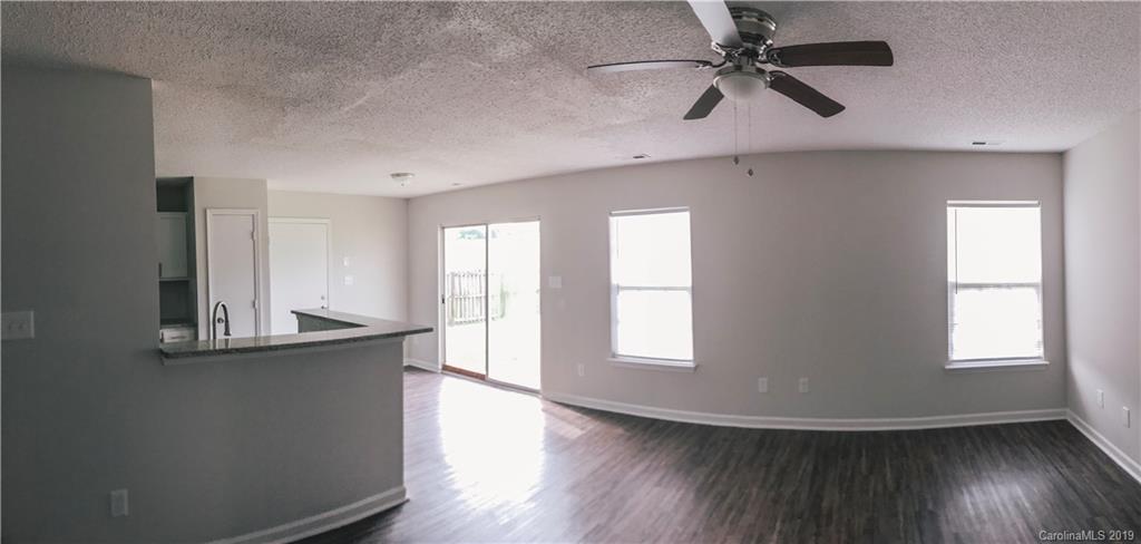 2039 Pimpernel Road Charlotte, NC 28213 - Photo 10 of 44 wooden floor in an empty room with a window