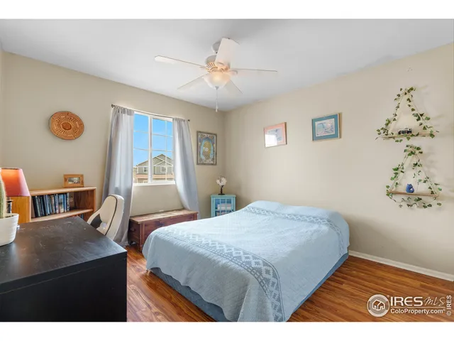 a bedroom with a bed and a bookshelf