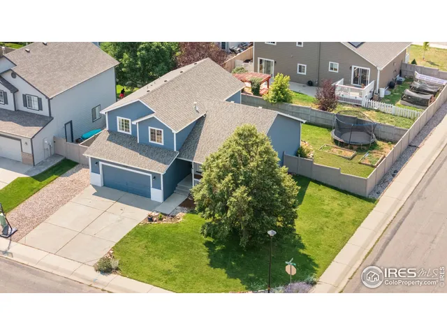 a aerial view of a house with a garden and a yard