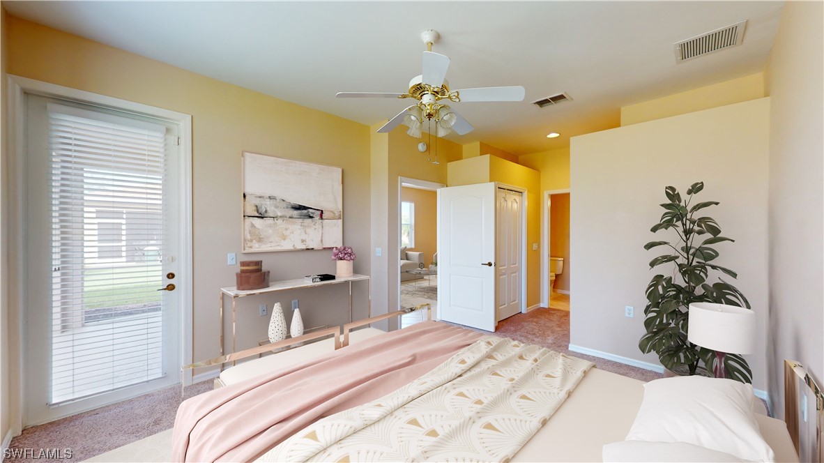 21540 Portrush Run Estero, FL 33928 - Photo 18 of 32 a bedroom with a bed and a chandelier