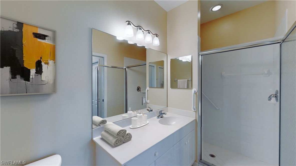 21540 Portrush Run Estero, FL 33928 - Photo 20 of 32 a bathroom with a sink and a mirror