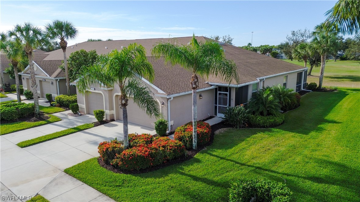 21540 Portrush Run Estero, FL 33928 - Photo 2 of 32 a front view of a house with a garden and plants