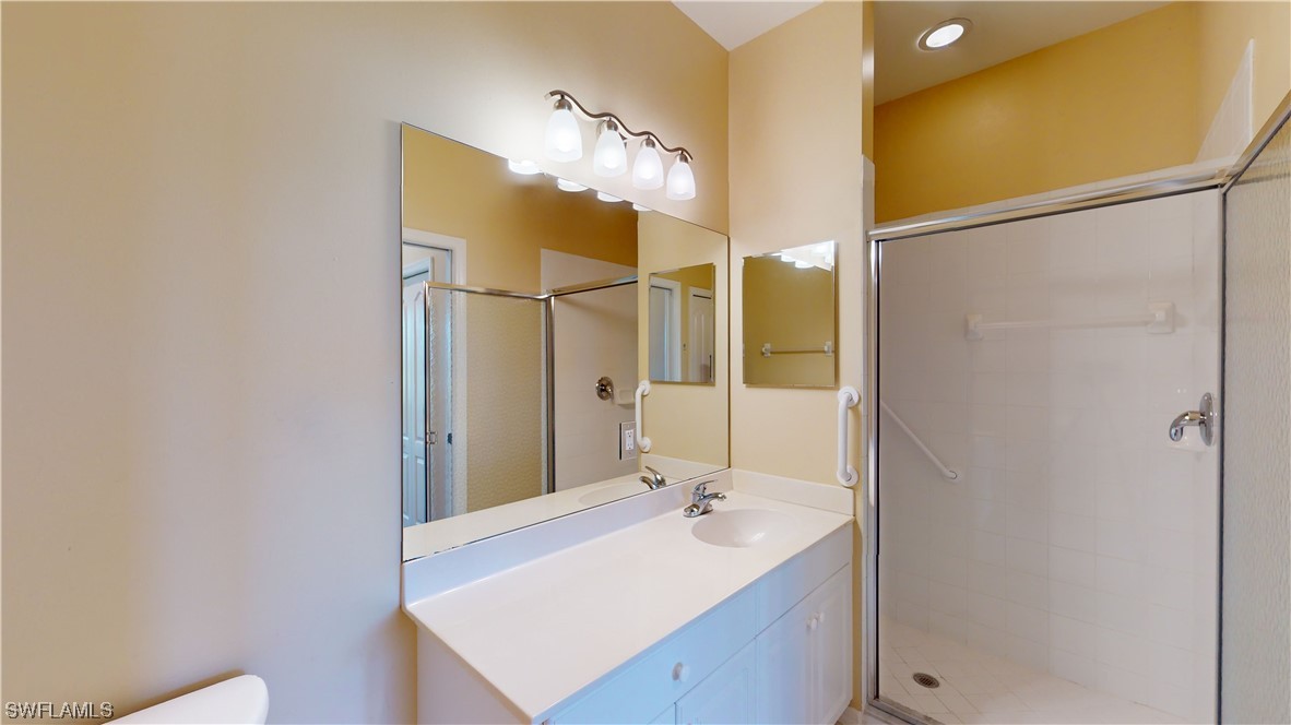 21540 Portrush Run Estero, FL 33928 - Photo 21 of 32 a bathroom with a sink and a mirror